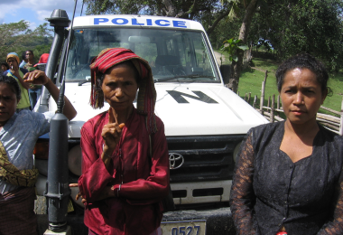 Two Timorese women pose in front of a UN truck on election day in 2007