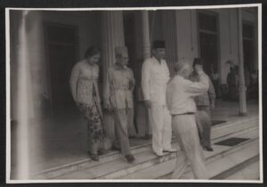 First Lady Fatmawati, Foreign Minister Haji Agus Salim, President Sukarno, and Dr. Frank step out of the Indonesian presidential palace